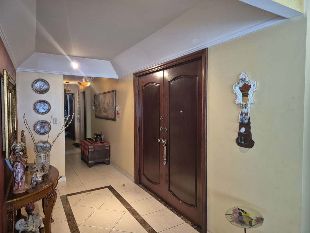 Bright living and dining room with large windows and ocean view balcony at PH Agua Marina in Coco del Mar