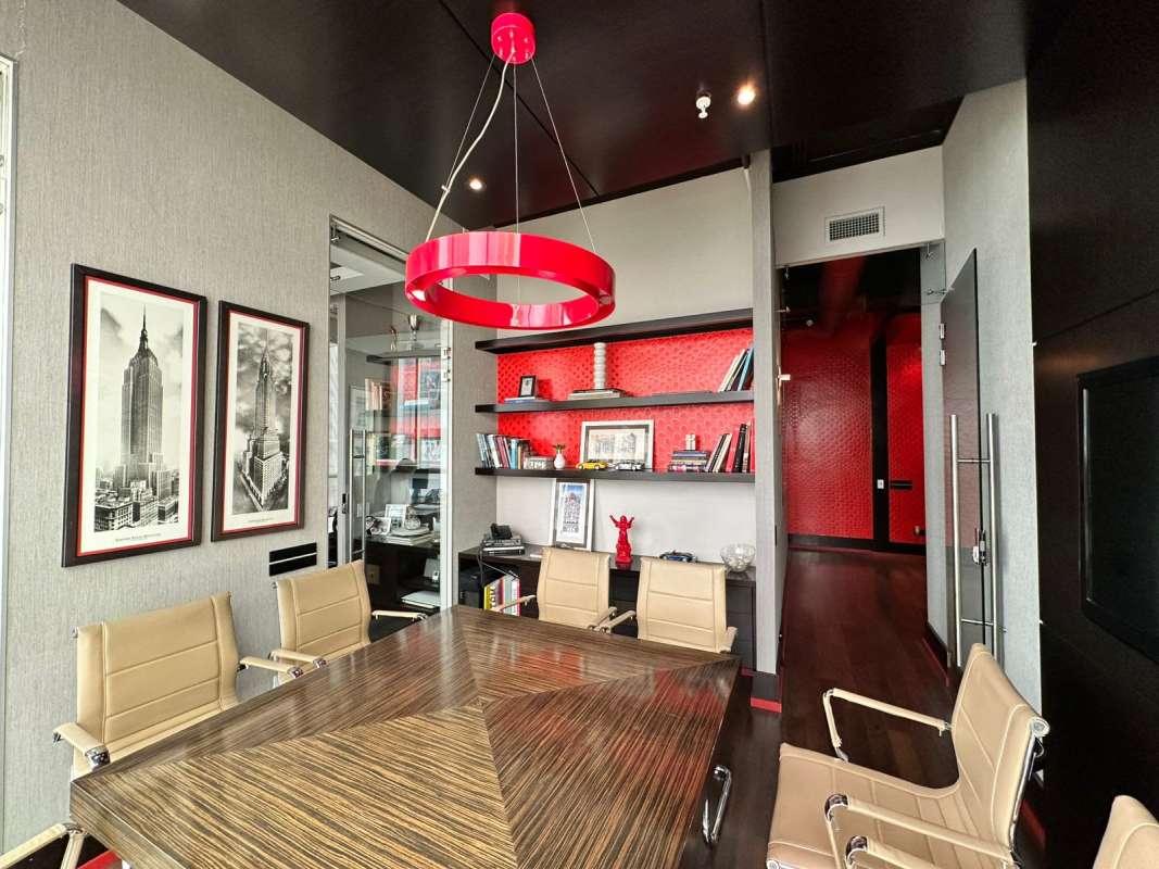 Conference room featuring large windows, beige chairs, wood table at PH BICSA Panama office for sale