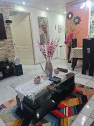 Compact kitchen with white cabinets and tile backsplash in Arraiján house