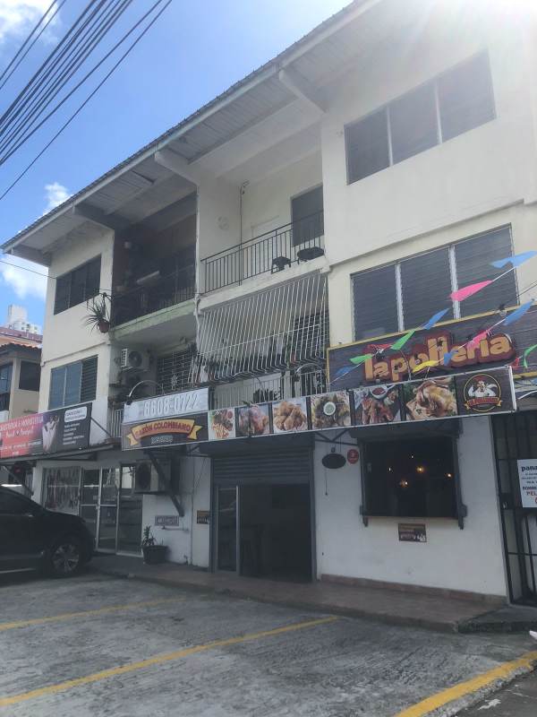 Bright living room with tiled floor, window with bars, open concept towards kitchen in Edificio Mercedes Elidas