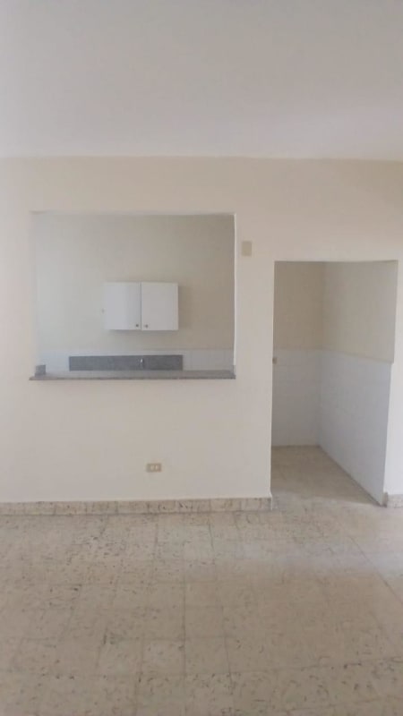 Minimalist kitchen with granite counter and white cabinets in Edificio Mercedes Elidas Carrasquilla