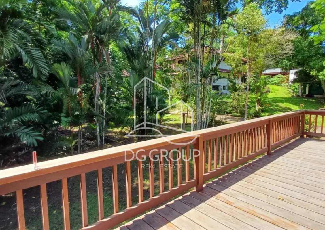Wooden deck with railing overlooking tropical garden Clayton Panama rental house