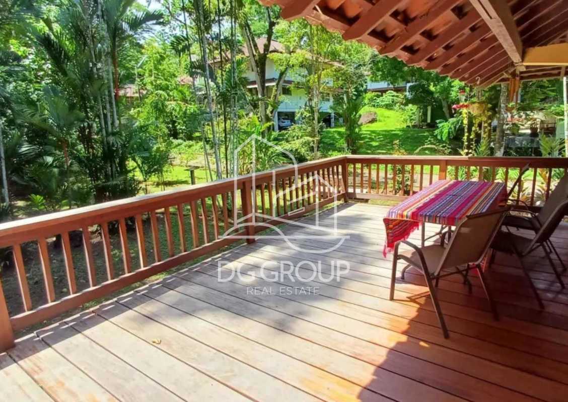 Wooden deck with colorful setup overlooking lush garden tropical rental Clayton house Panama