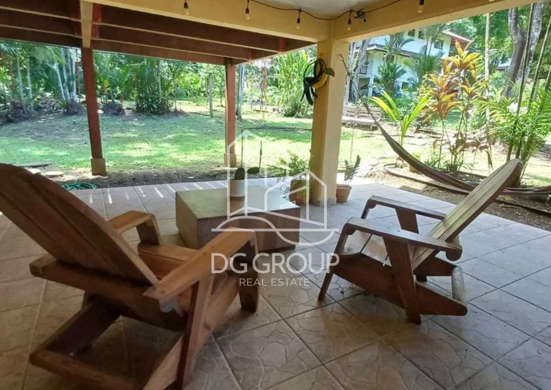 Covered outdoor lounge with hammock and garden lush greenery Clayton Panama rental home
