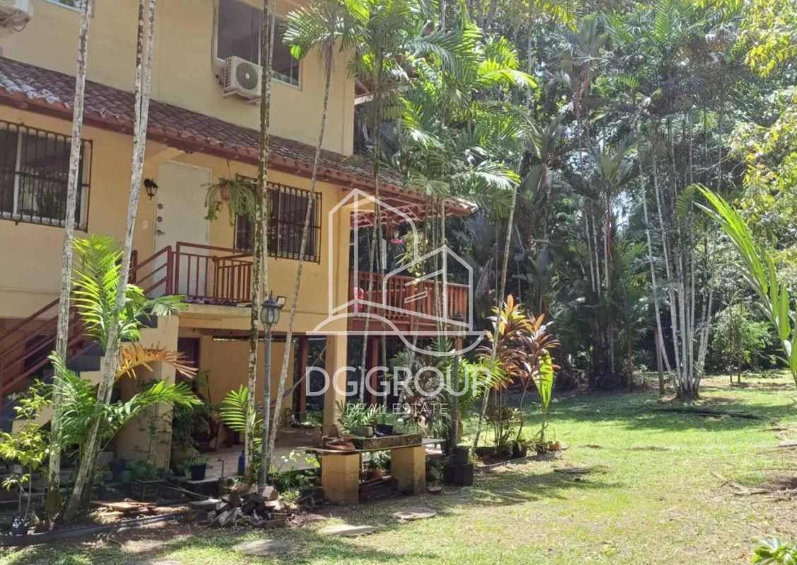 Two-story tropical house wrap-around balcony lush garden Panama Clayton rental