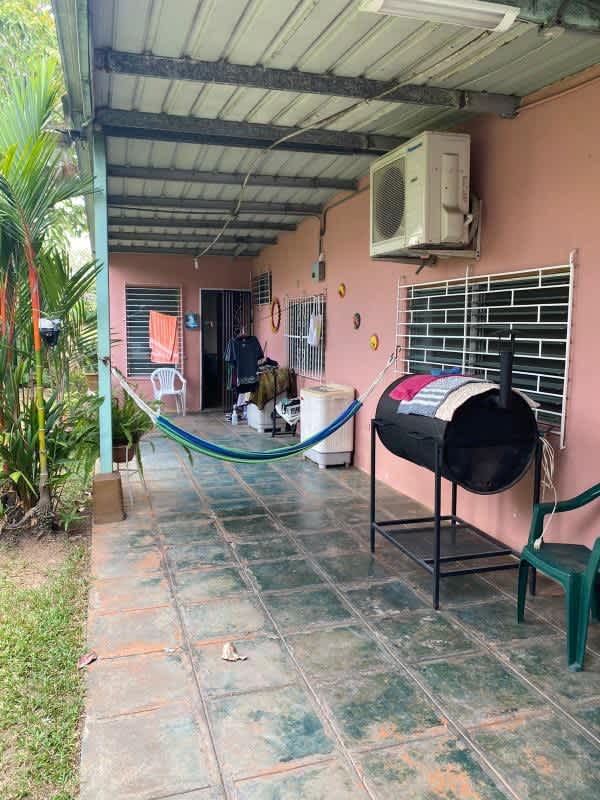 Outdoor patio with pink wall hammock barbecue tiled floor Ciudad Radial Panama