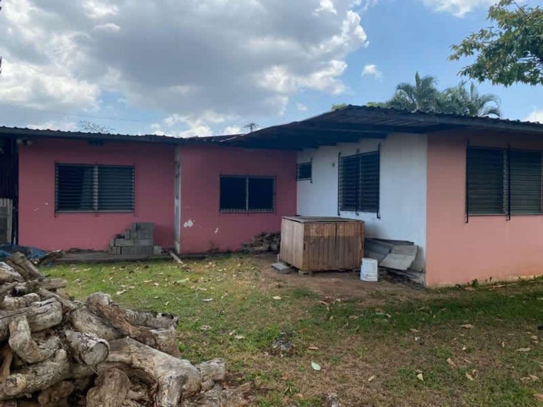 Front facade of single story residence with metal roof and fenced yard Ciudad Radial Don Bosco Panama