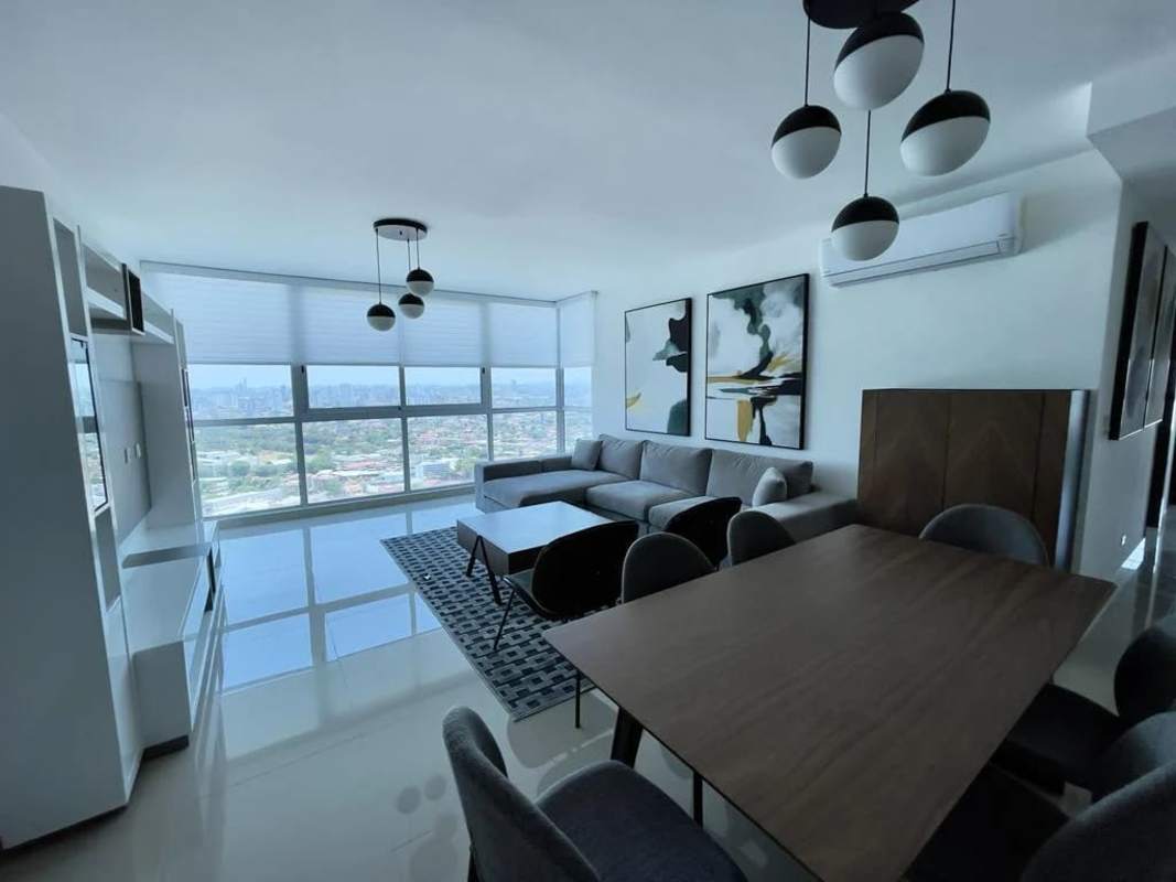 Living dining open-plan furnished apartment, large windows, city skyline at PH Top Tower Costa del Este Panama