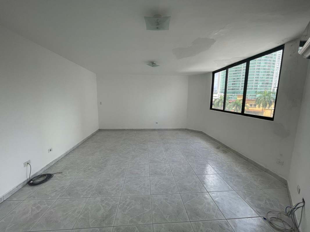 Bedroom with large window overlooking ocean and skyline in PH Rocamar Avenida Balboa Panama
