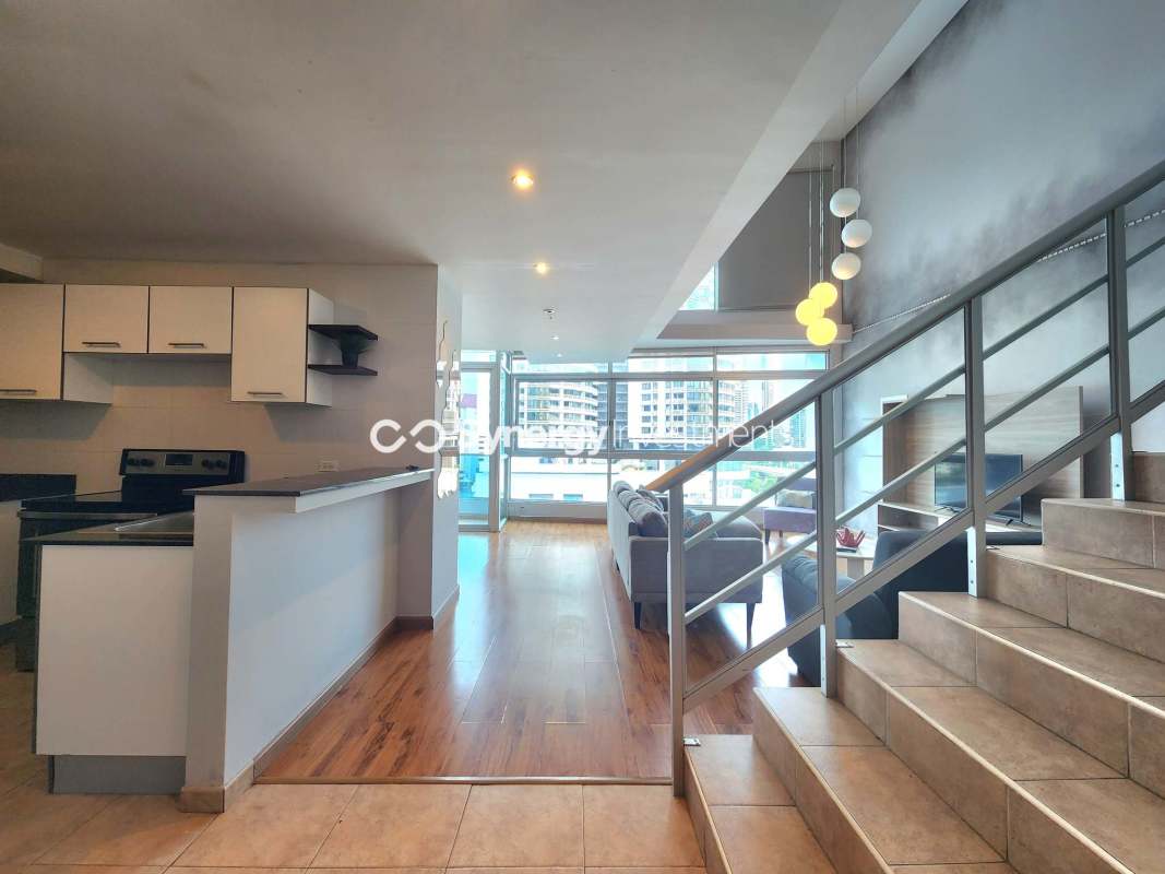 Loft bedroom with large windows and city view at PH BICSA Tower Panama rental