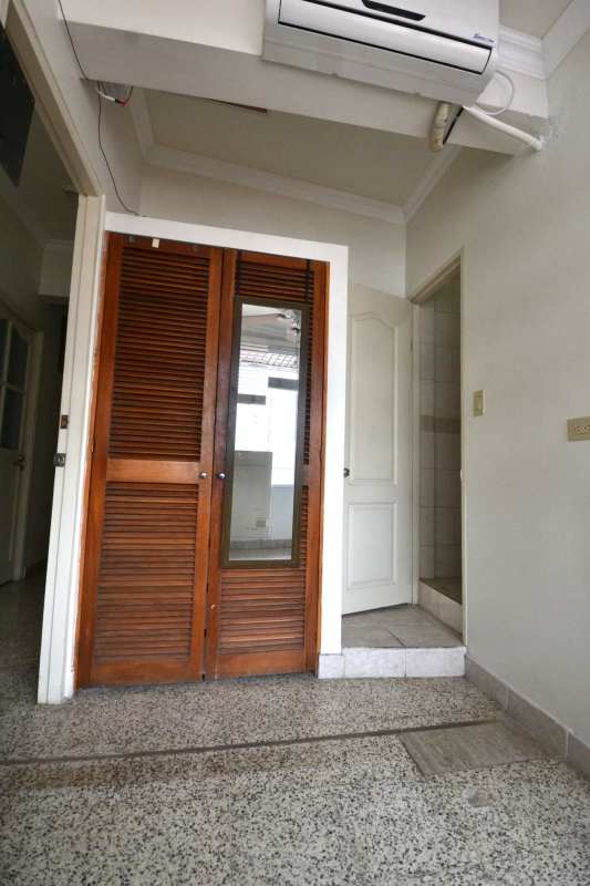 Interior hall with mirrored wooden closets, terrazzo flooring, split AC at PH Cádiz investment apartment Panama