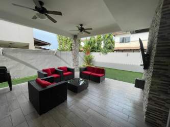 Covered outdoor patio with fans and TV at duplex in PH Woodlands Panama Pacifico