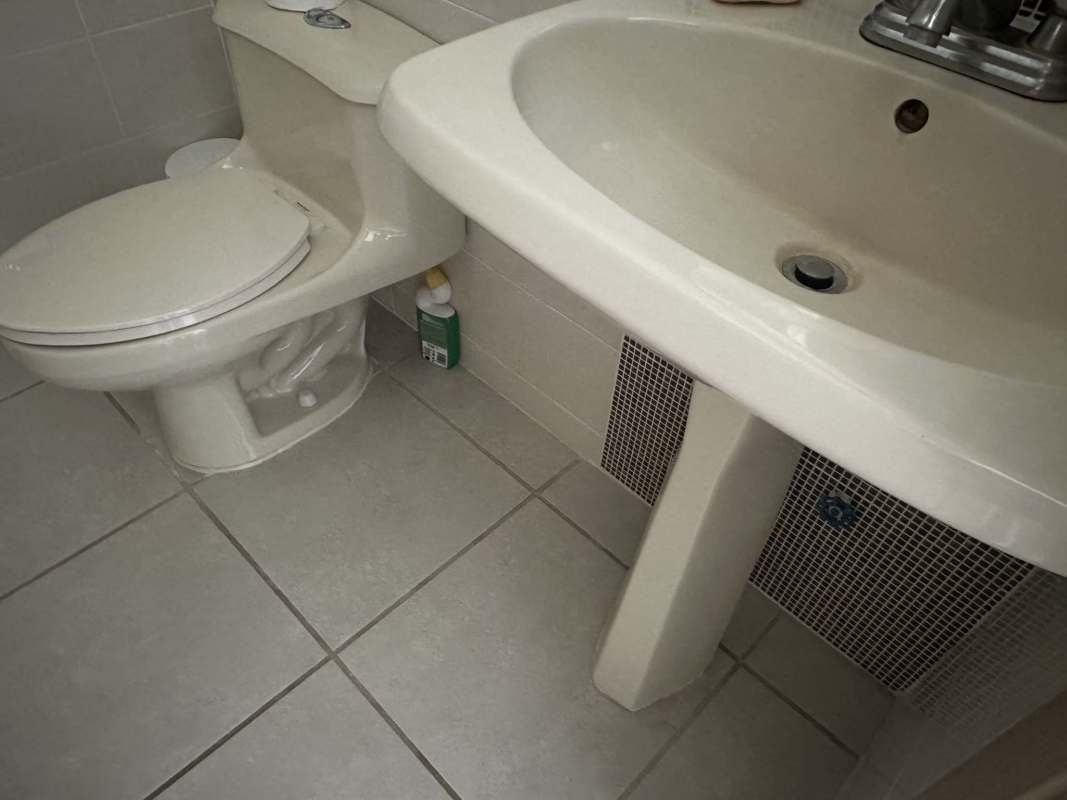 Updated bathroom with glass-enclosed shower and pedestal sink PH Victoria Brisas del Golf Panama