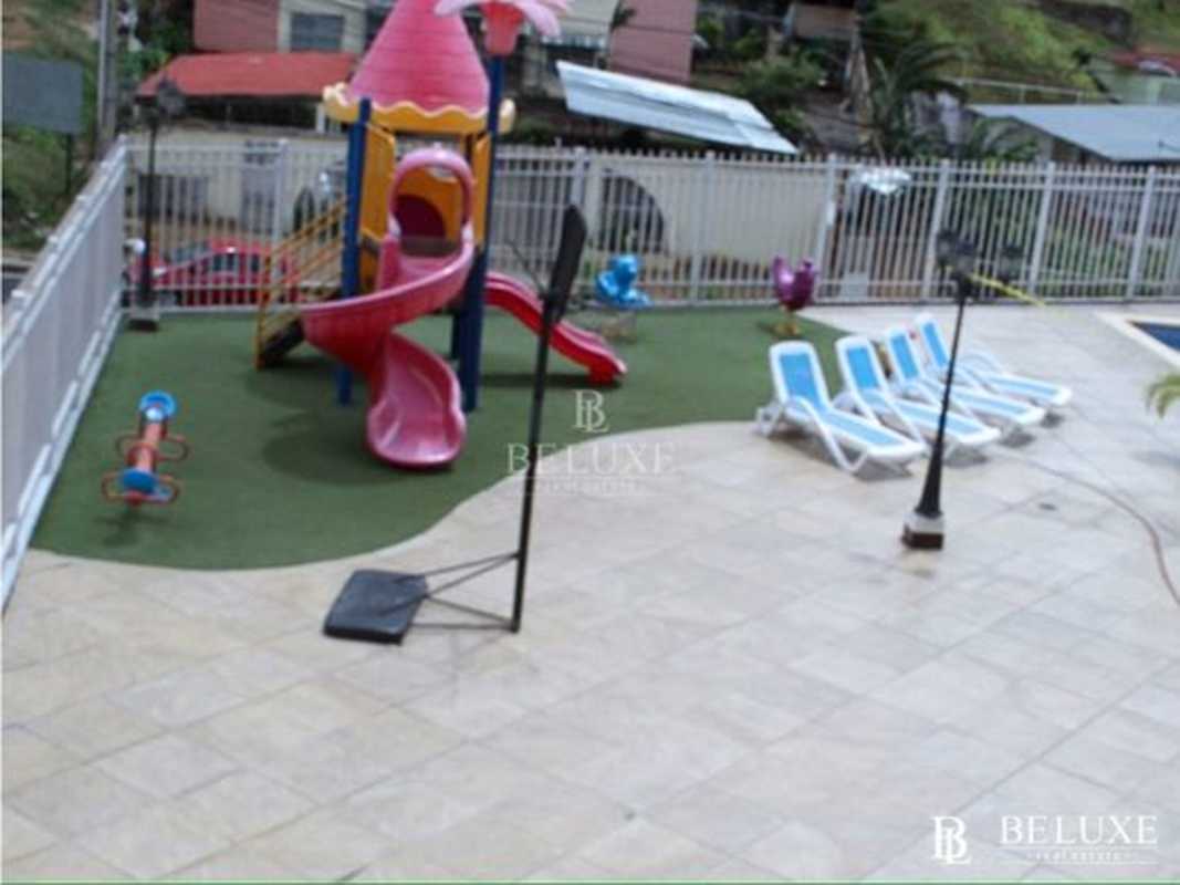 Facade of Vista Marina Towers high-rise building with children's playground in Panama City