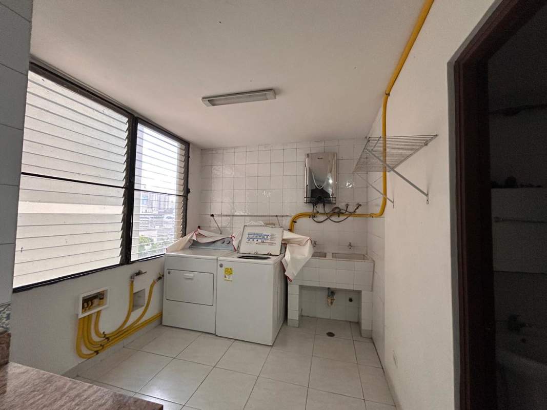 Outdoor swimming pool surrounded by residential tower and city backdrop at PH Brisas de Obarrio