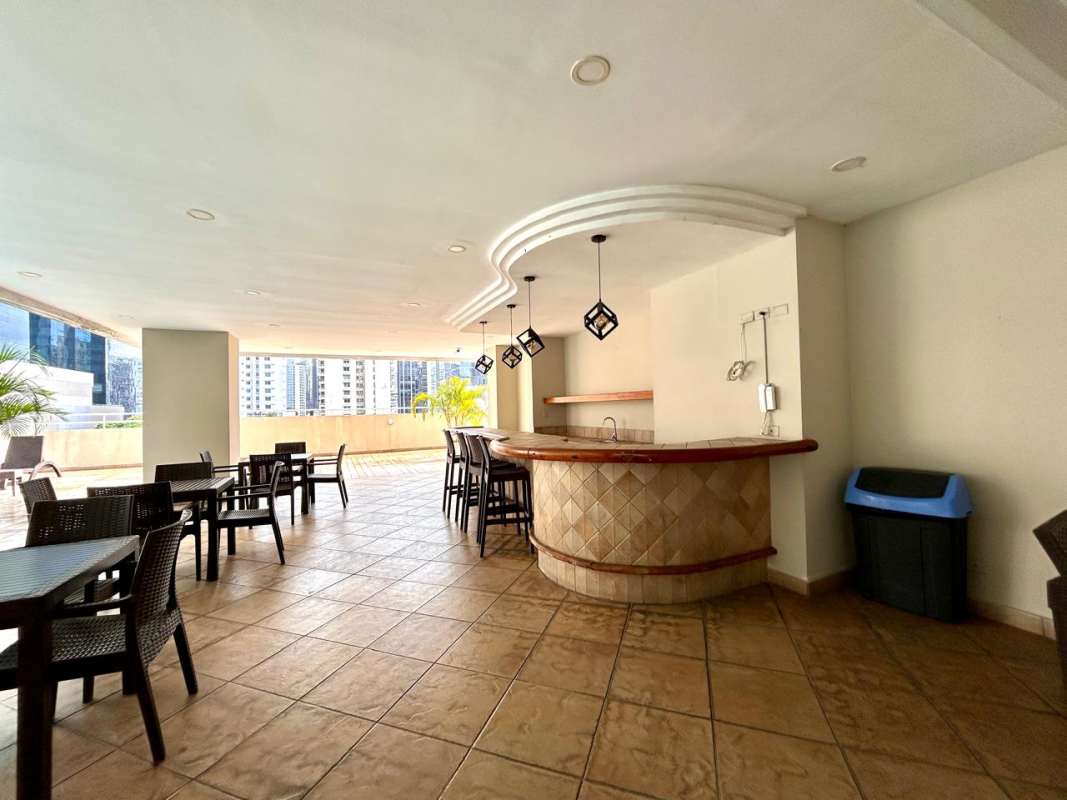 Modern lobby area with marble flooring, black sofas, art and large reception at PH Brisas de Obarrio Panama City