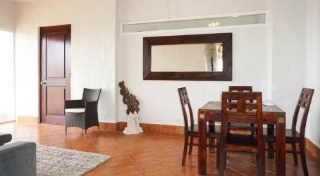 Dining area with terracotta tiled floors and modern furniture in Vista Mar beachfront condo Panama