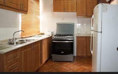 Functional kitchen with wooden cabinets granite countertops in Vista Mar condo Panama