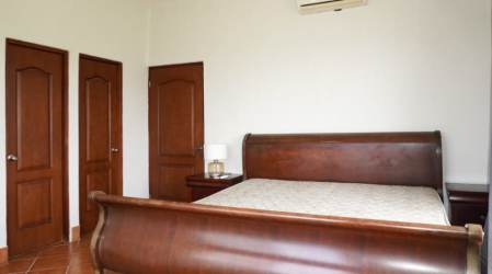 Third bedroom with AC white walls tile floors in Vista Mar Golf Beach Marina condo Panama