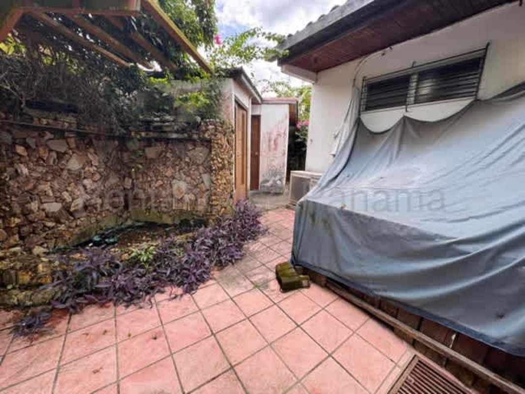Rustic patio with pergola garden bed and stone wall luxury house Altos del Golf Panama City