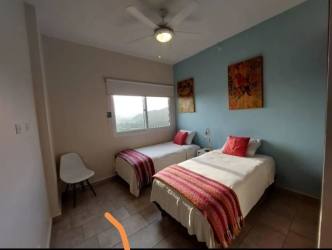 Guest bedroom with twin beds, large windows PH Tucan Panama Pacifico