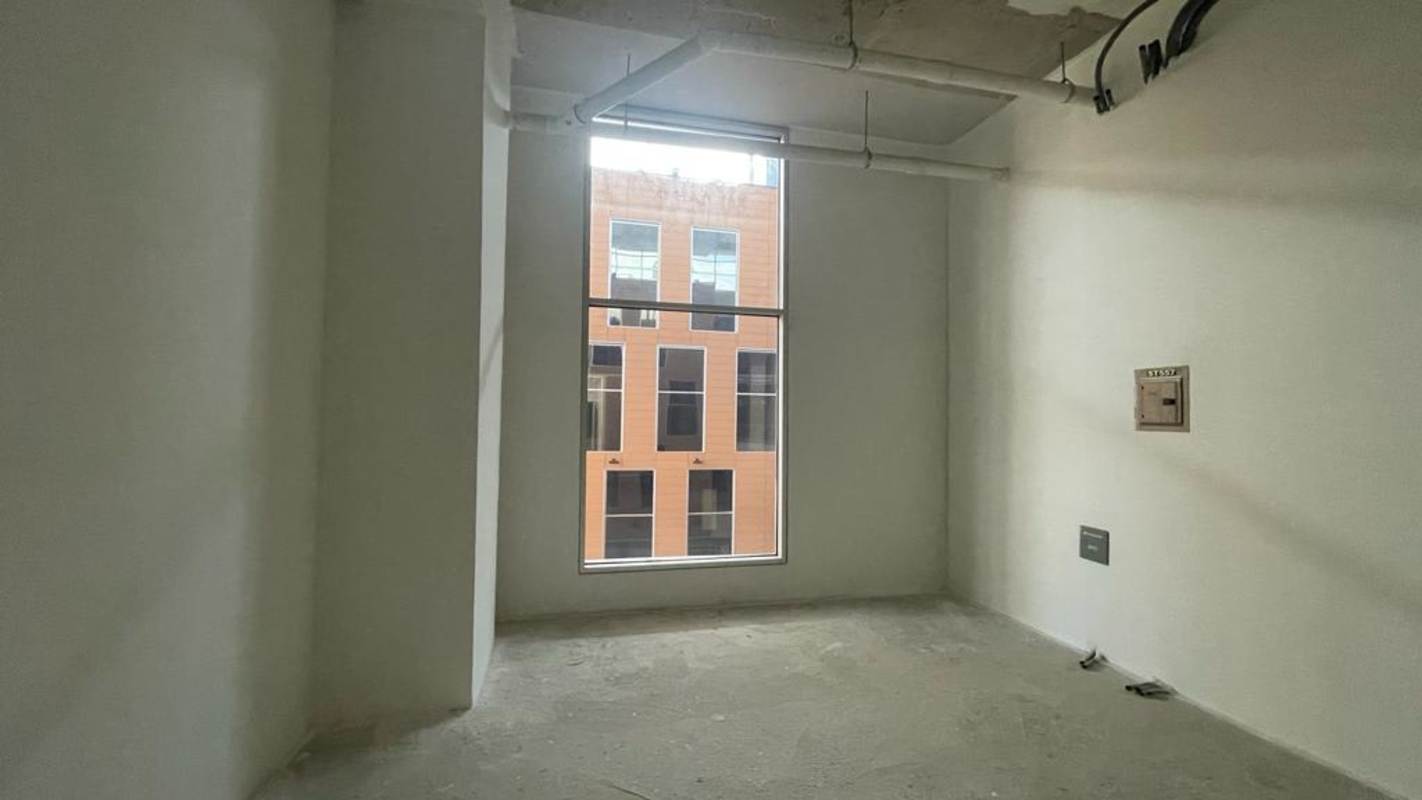 Concrete interior with exposed ceiling and large window readiness for customization Panama City