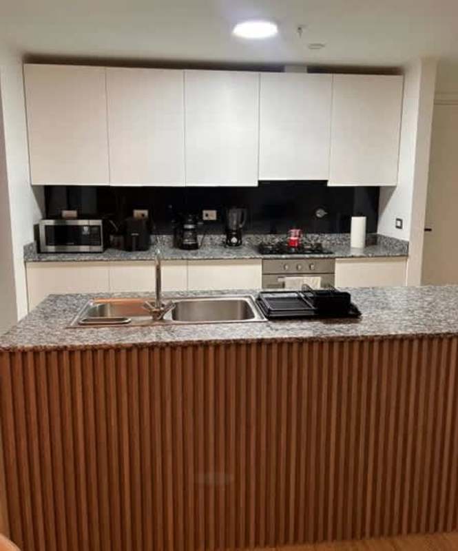 Bedroom with upholstered bed, neutral tones, roller shades in PH Coco del Mar for sale