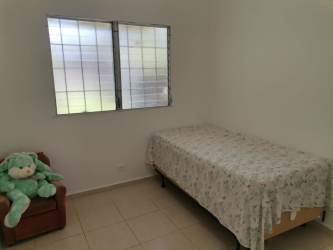 Bedroom with large window and tiled floor in Arraiján affordable residence Panama