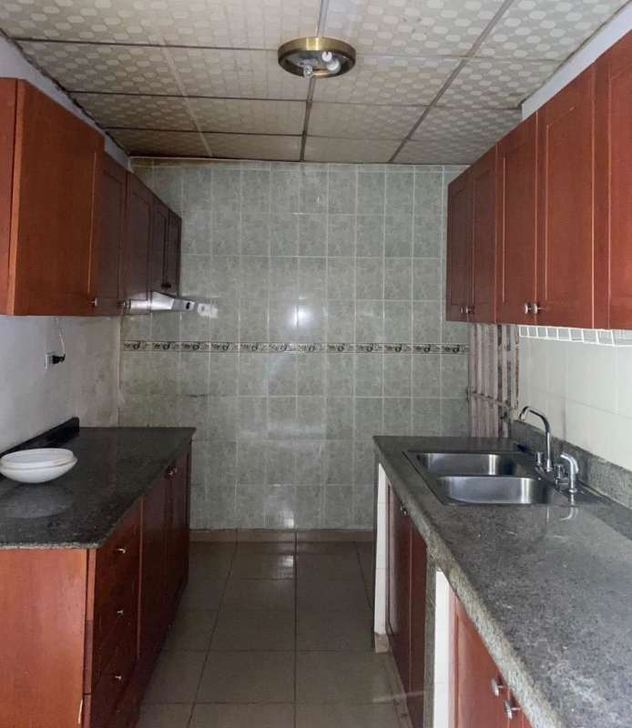 Bright living room with ceiling fan, tiled flooring, yellow accent wall in El Crisol Panama rental house
