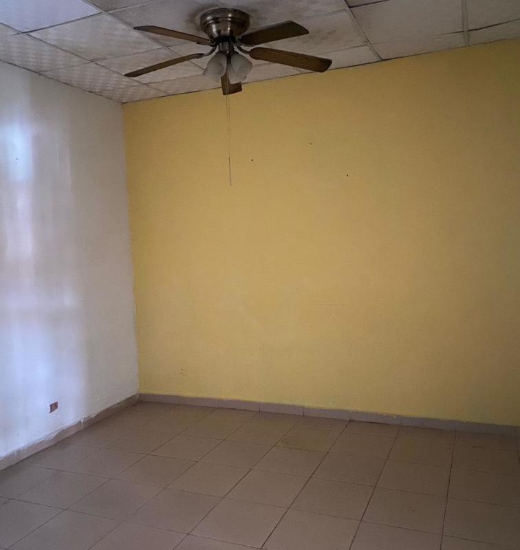 Narrow galley kitchen with brown cabinets, granite countertops, double sink in El Crisol Panama rental home