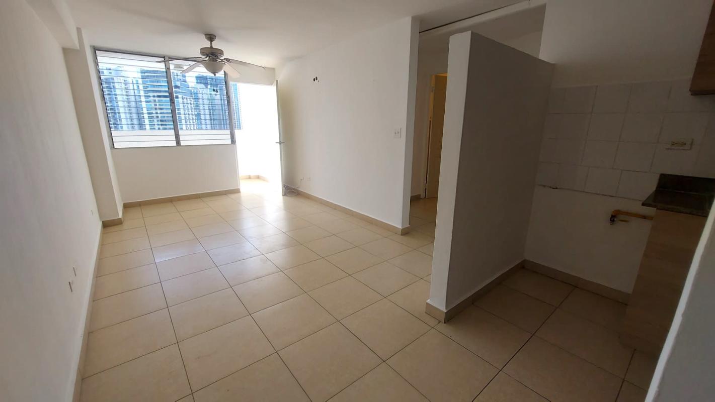 Living room with natural light and access to balcony overlooking city in PH Bella Vista Gardens