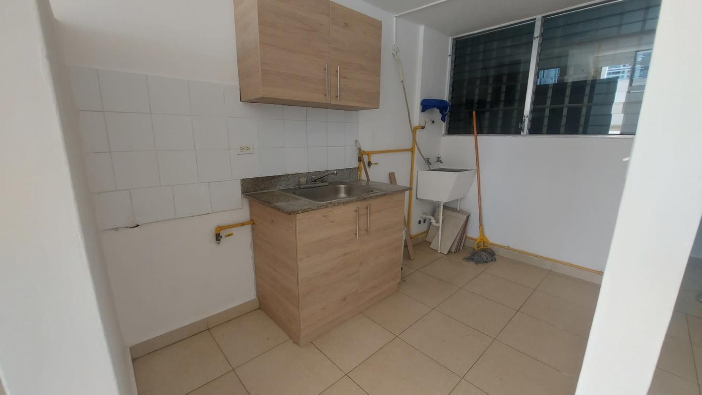 Laundry room with utility basin and window in PH Bella Vista Gardens apartment in Panama City