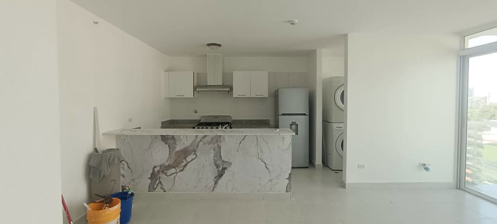 Open living dining area with large balcony, washer dryer, marble countertop kitchen in PH Metropolitan One Panama