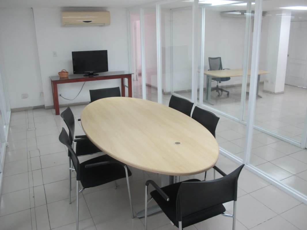Modern meeting room with glass walls and conference table full floor office Torre Delta