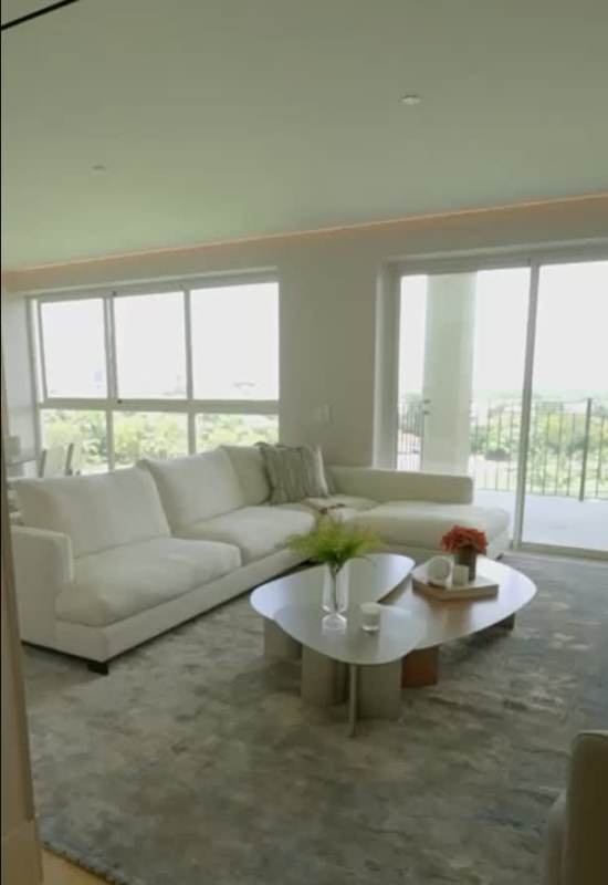 Contemporary kitchen with marble counters wood cabinets pendant lighting in Santa María