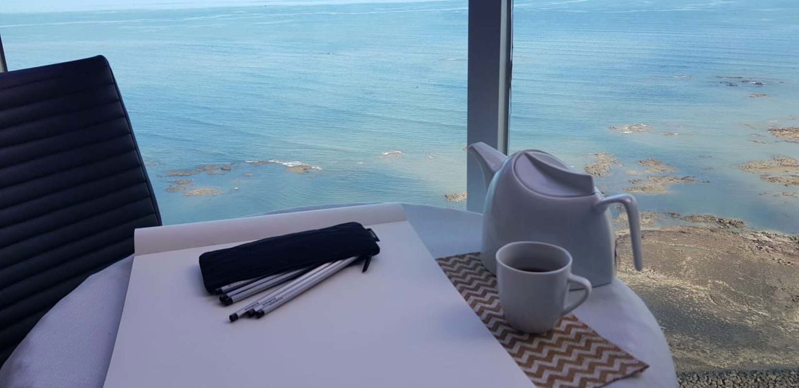 Dining space with large floor-to-ceiling window and Pacific Ocean view in PH Terrasol Panama