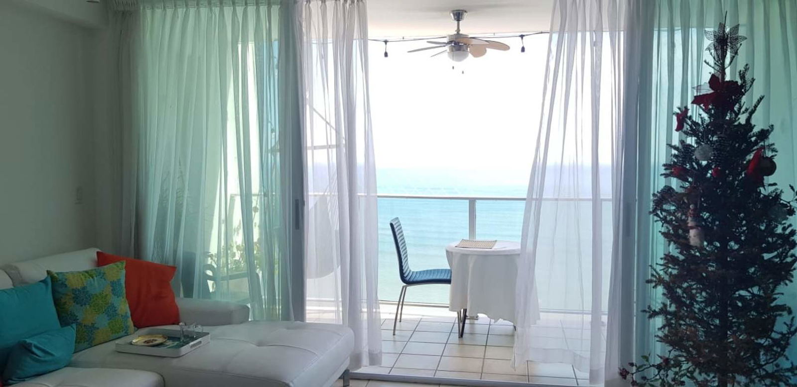 White sofa, decorated balcony with Pacific Ocean view in PH Terrasol San Francisco Panama