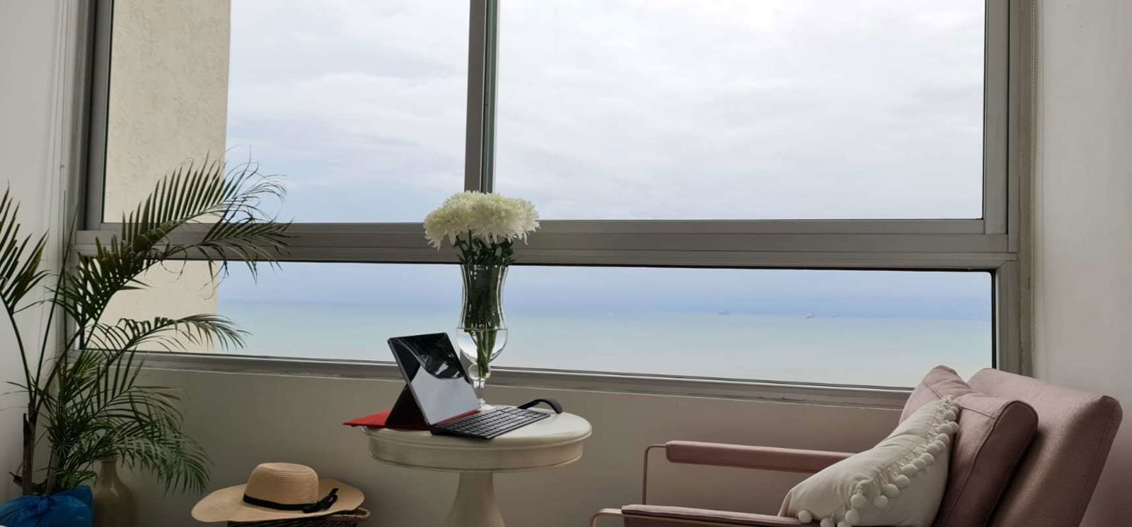 Cozy sunroom balcony setup with Pacific Ocean views in high-rise PH Terrasol Panama City