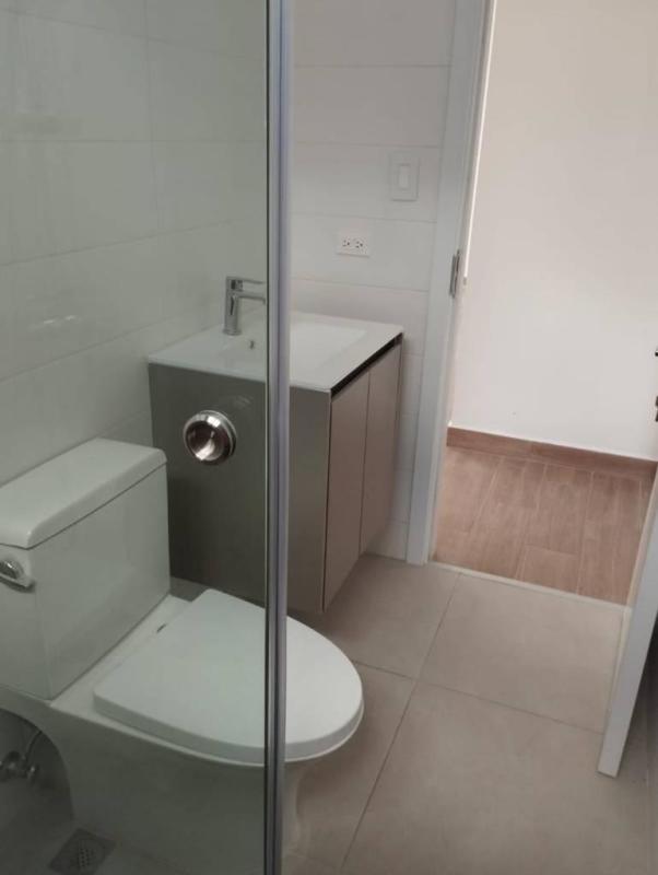Compact modern bathroom with tiled walls and walk-in shower PH Le Mans Panama