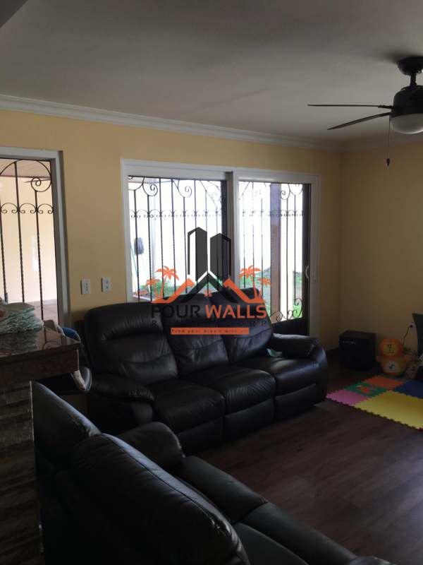 Kitchen area with modern cabinets, tile backsplash in Brisas del Golf house for sale Panama