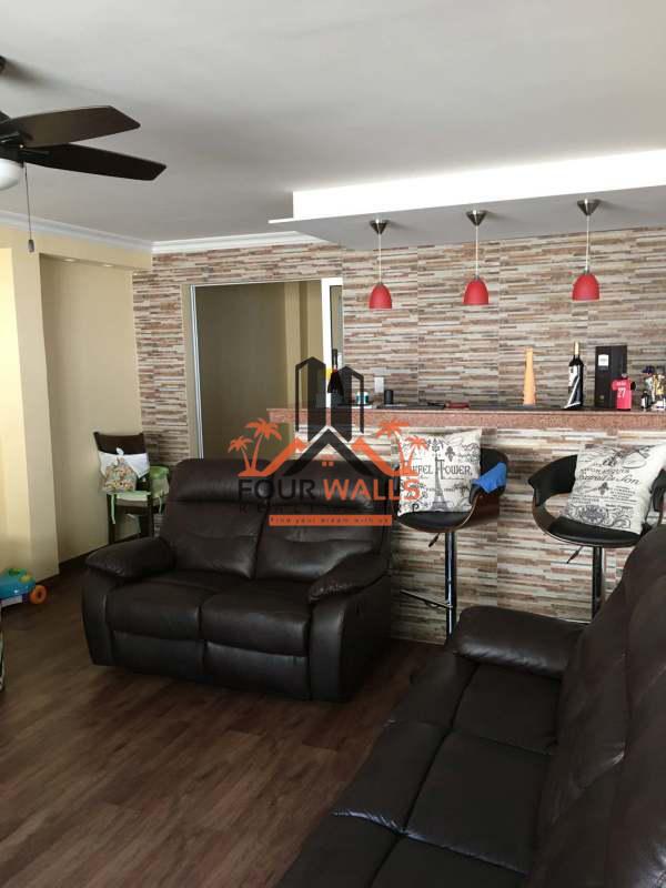 Bright living room with ceramic tile, large window and ceiling fan of house for sale in Brisas del Golf Panama