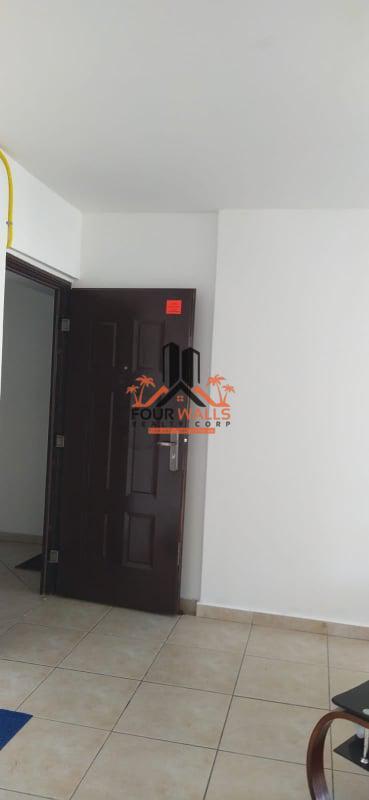 Living room with large window and air conditioning overlooking urban skyline PH San Francisco Bay Panama City