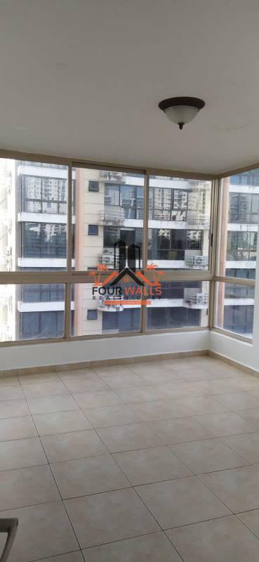 Entrance hallway with elegant wood door and beige tiles in PH San Francisco Bay Panama City