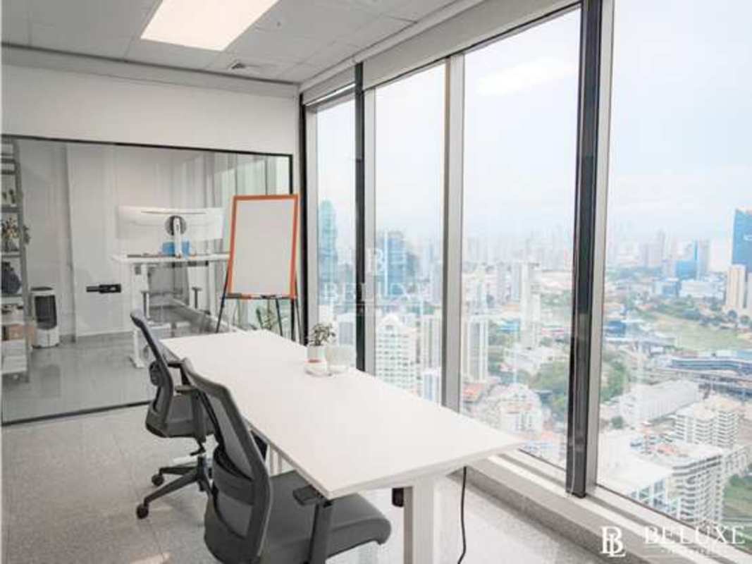Private conference area with glass walls and modern furniture at PH BICSA Tower Panama