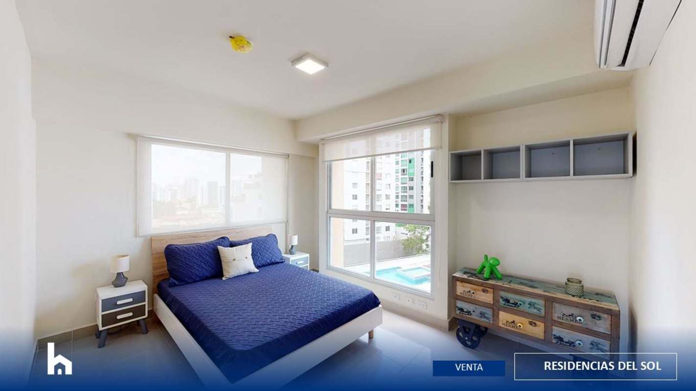 Bedroom with large window overlooking city skyline at PH Residencias del Sol Carrasquilla