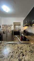 Dining room with glass table and window blinds Residencial Las Verdes Panama house for rent