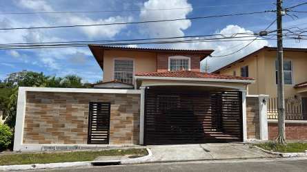 Front view of two-story gated residence with driveway in Arraiján Panama