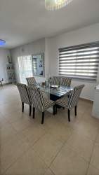 Two-story cream-colored house front with driveway in Residencial Las Verdes Panama