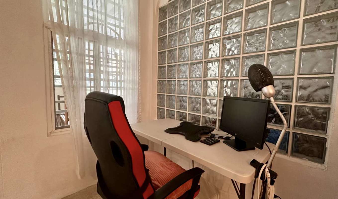 Bedroom with tiled floor, AC, fan and large barred windows Villa de las Fuentes Panama