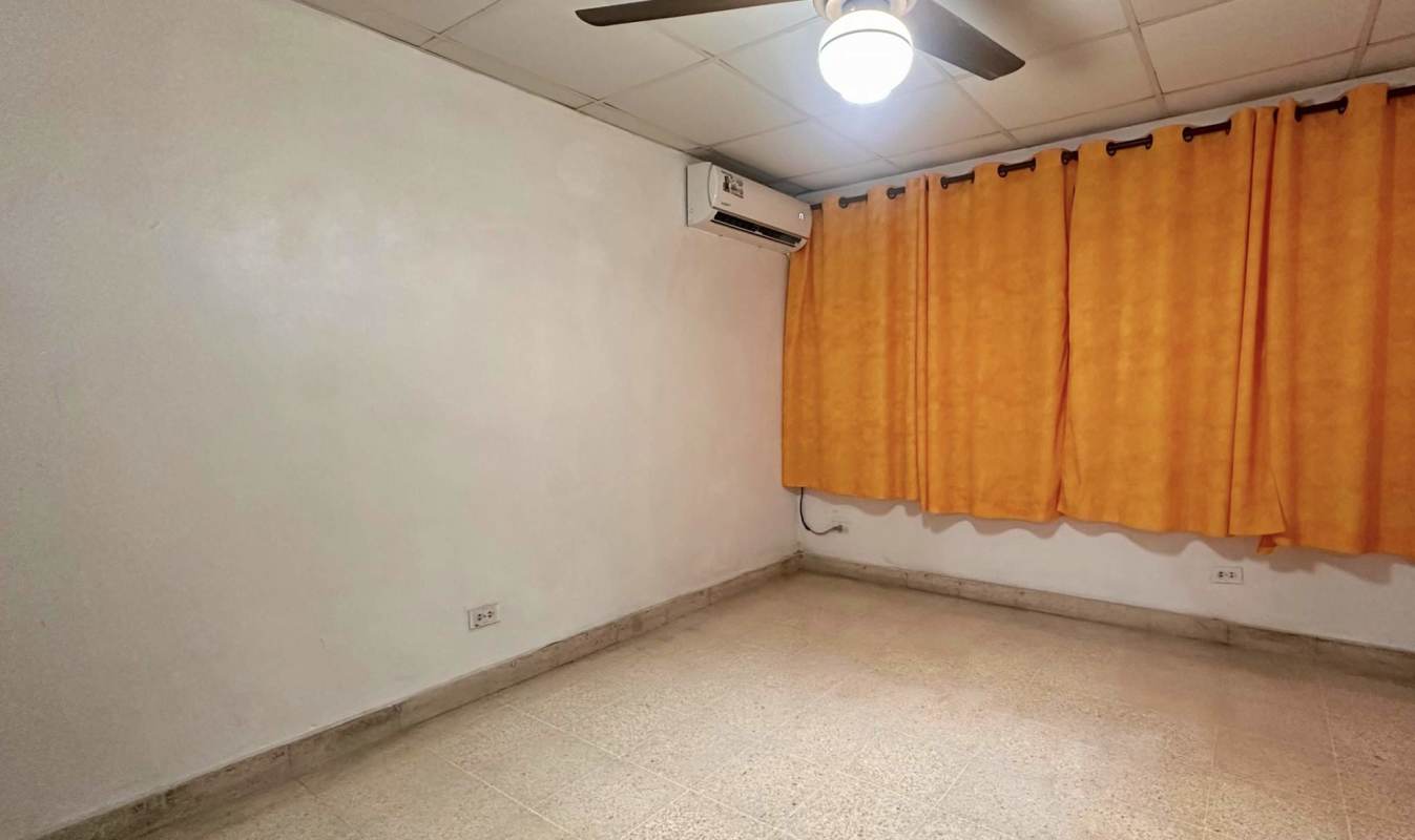 Bedroom with large window, security bars, curtains and AC Villa de las Fuentes Panama